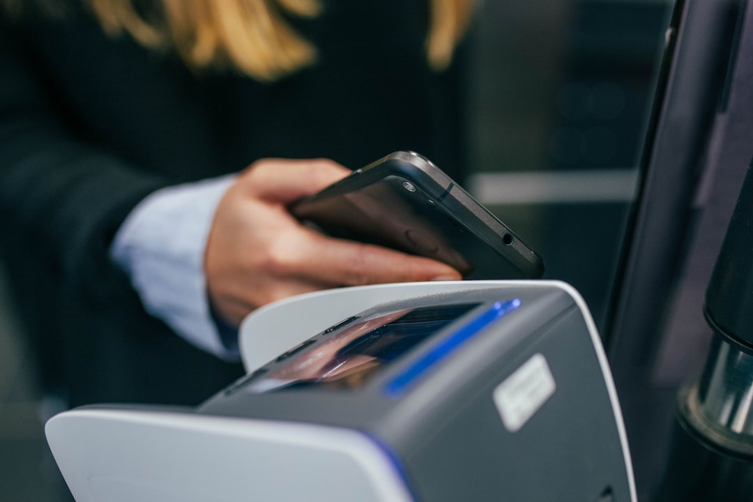 shallow focus photography of person holding smartphone