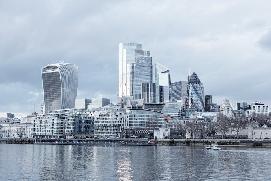 Contemporary multistory high rise business centers located on embankment with trees near Thames river in London city