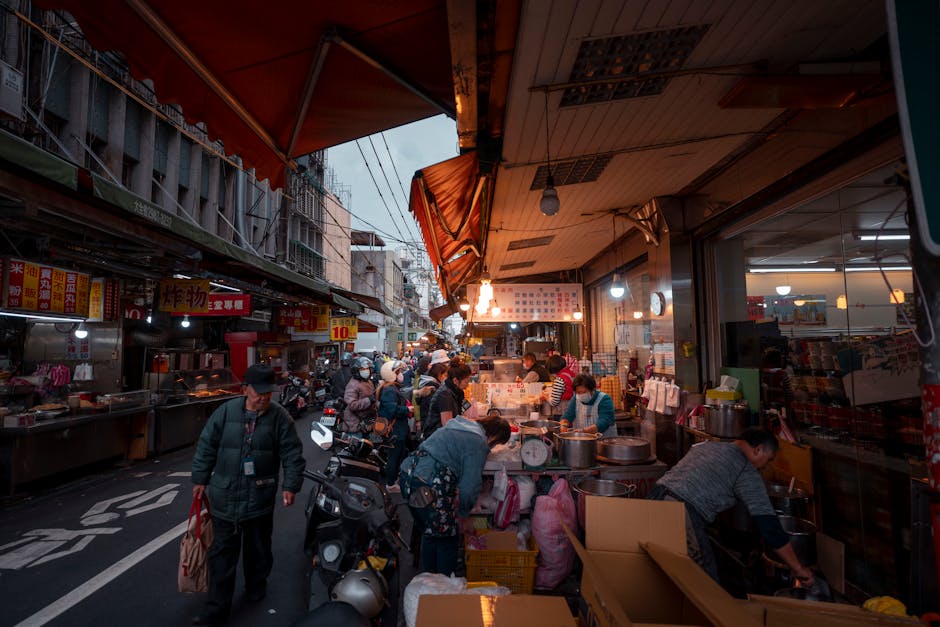 People are walking down a street in a city