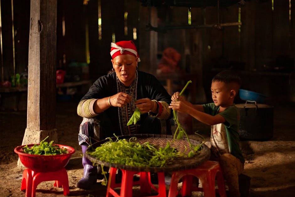 Photo of Woman and Boy Sitting and Cleaning Vegetables