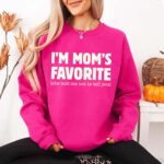 Women Wearing “I’m Mom’s Favorite” DTF Transfer crewneck sweatshirt